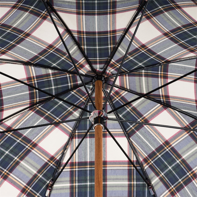 Close-up view of a plaid-patterned umbrella interior with wooden shaft and black metal ribs