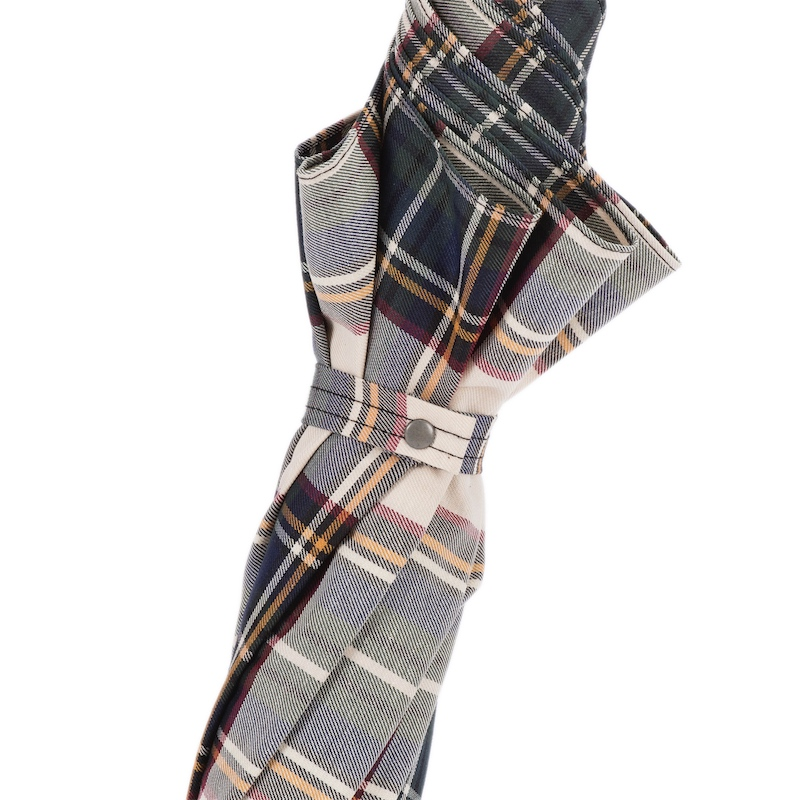 Folded plaid umbrella with navy, beige, and red check pattern secured by snap strap
