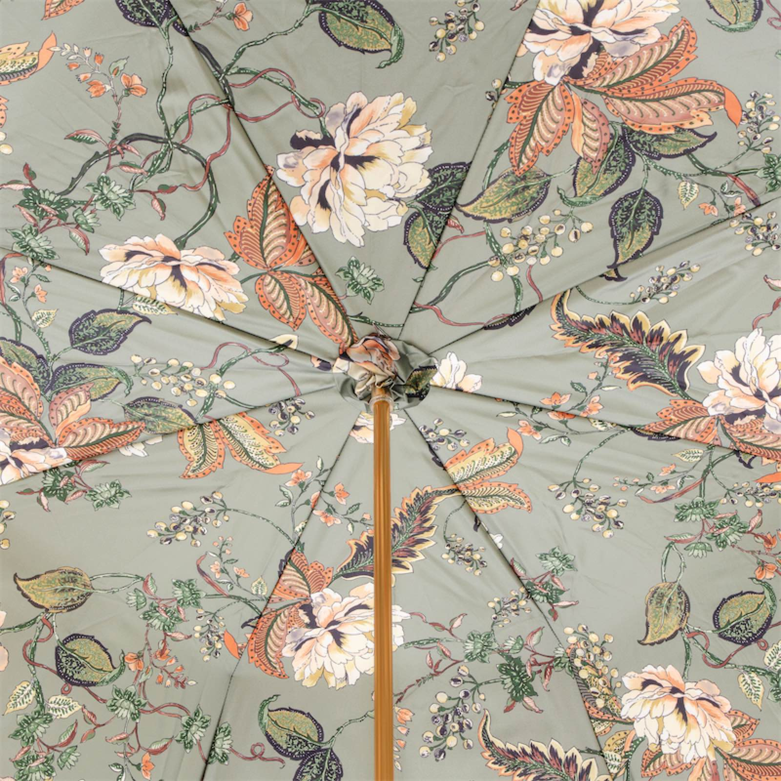 Floral patterned patio umbrella with green background and orange, cream flowers and leaves