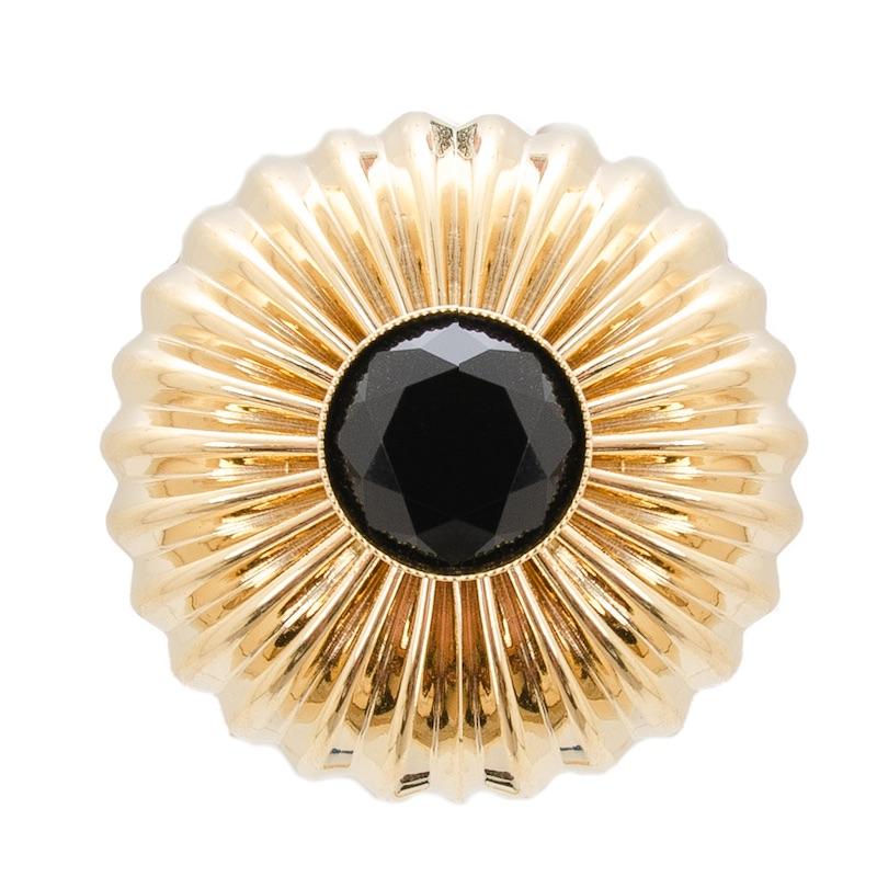 Gold sunburst ring with large black faceted stone centerpiece on white background