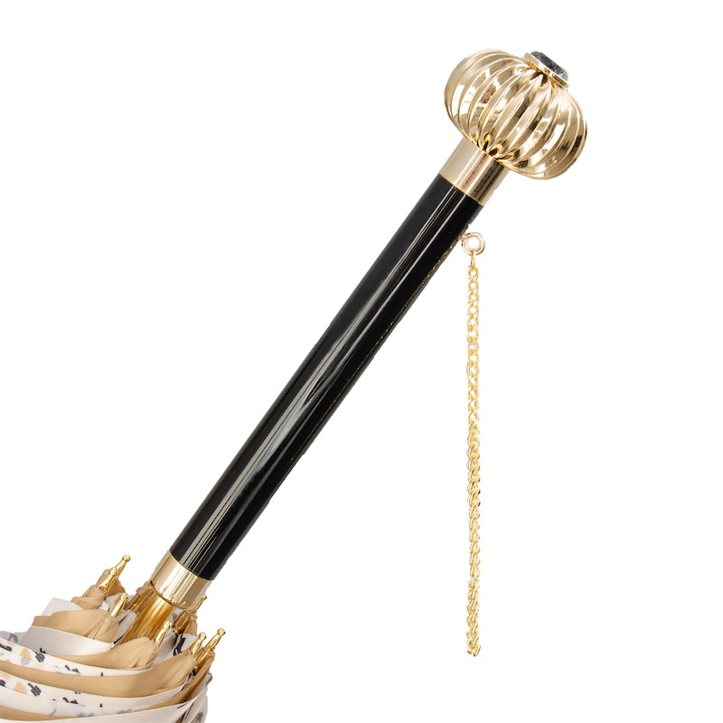 Elegant umbrella with a glossy black handle, gold crown top, and gold chain detail