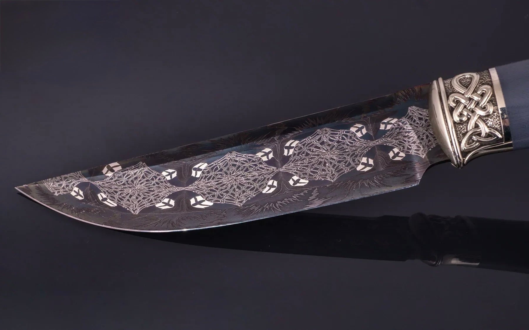 Decorative knife with intricate patterns on a dark background